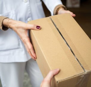 Pharmacist receives a package filled with medicines in a community pharmacy